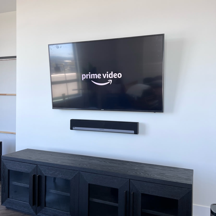 Wall-mounted TV with soundbar setup